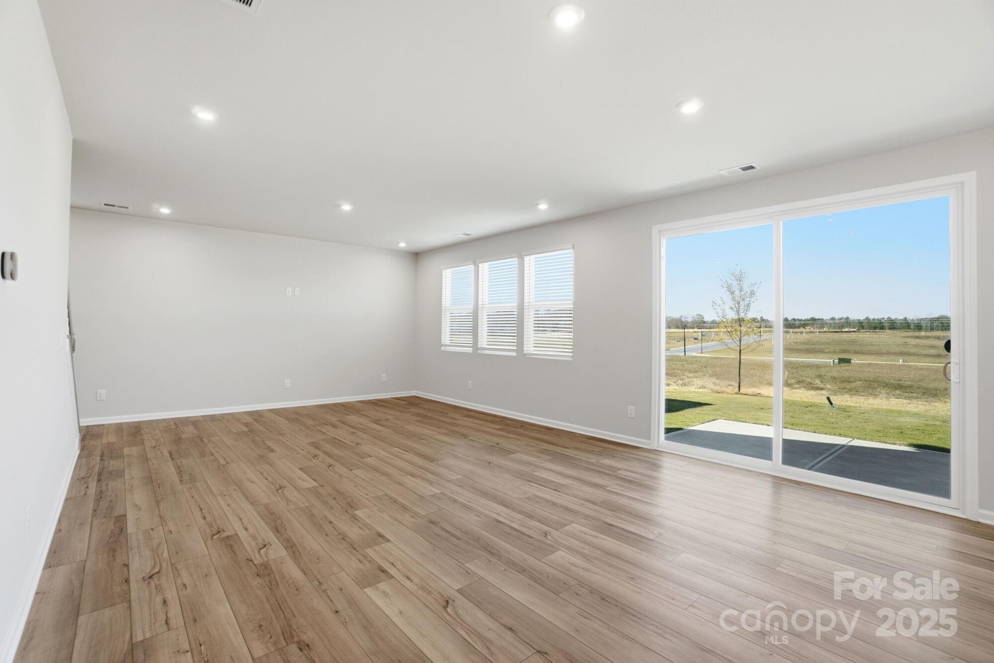 2664 Tillman Street Monroe, NC 28112 - Photo 8 of 25 wooden floor in an empty room with a window