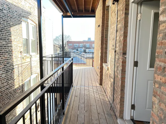 a view of a balcony with wooden floor