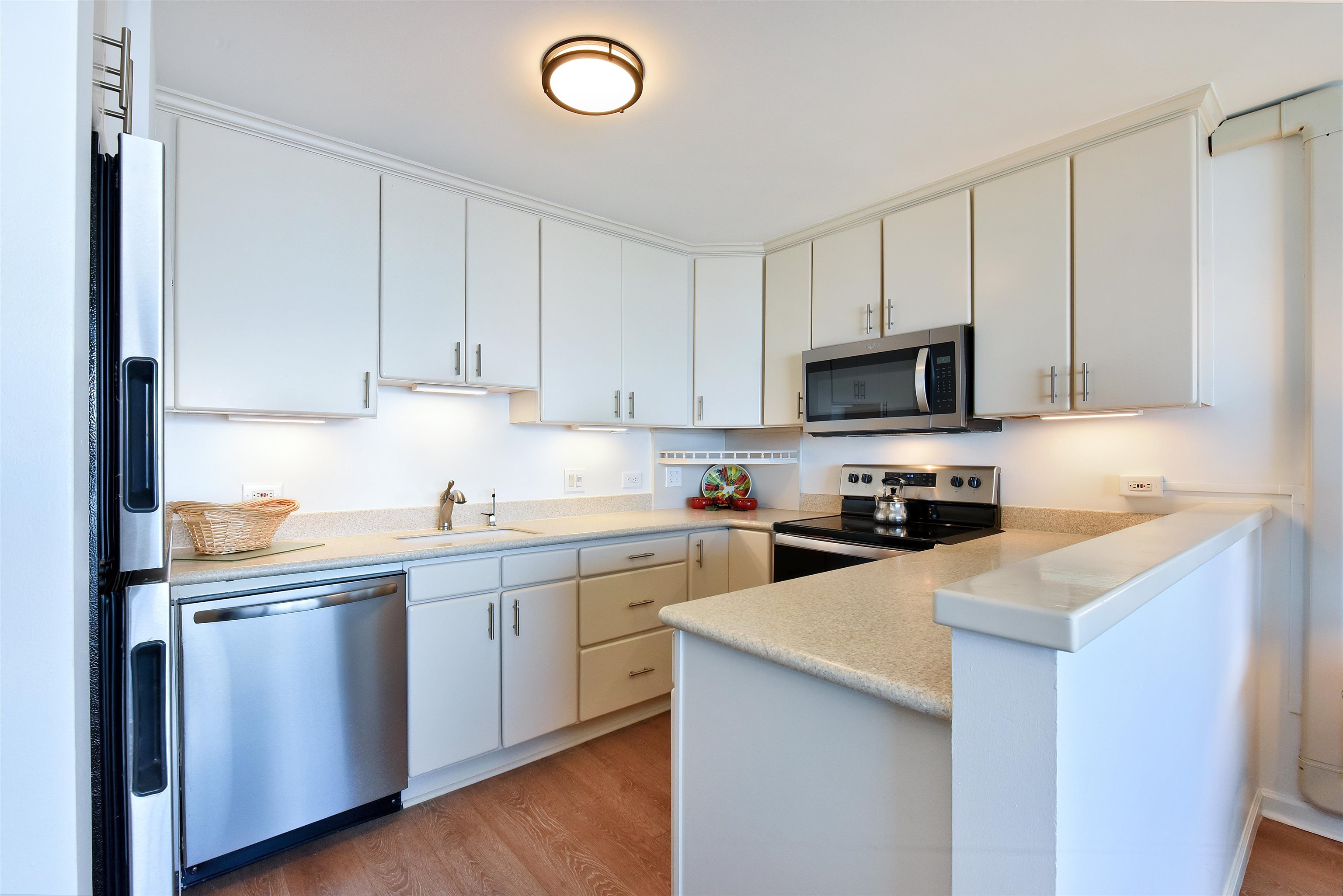 1403 Front Street, Unit 308 Lahaina, HI 96761 - Photo 11 of 35 a kitchen with cabinets appliances a sink and a counter top
