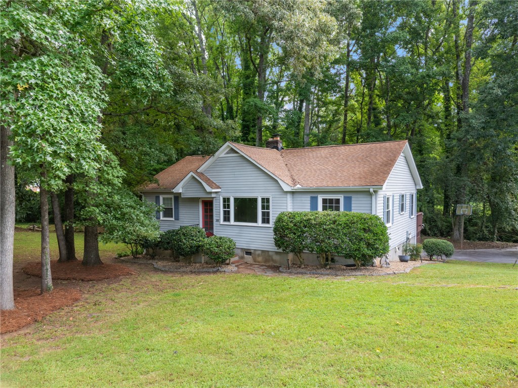 98 Blue Ridge Drive Clemson, SC 29631 - Photo 1 of 32 Mature trees frame a charming ranch home nestled on a grassy lawn.