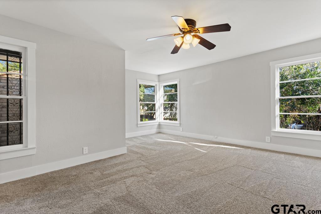2819 New Copeland Road Tyler, TX 75701 - Photo 25 of 39 an empty room with ceiling fan and windows