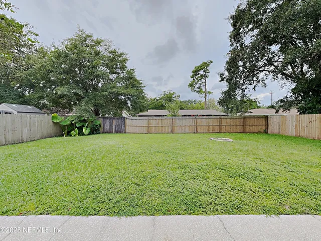 a picture of a yard with a tree