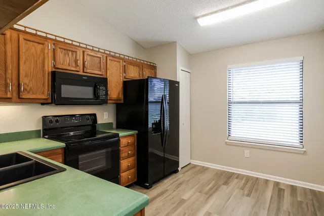 a kitchen with a refrigerator stove and microwave
