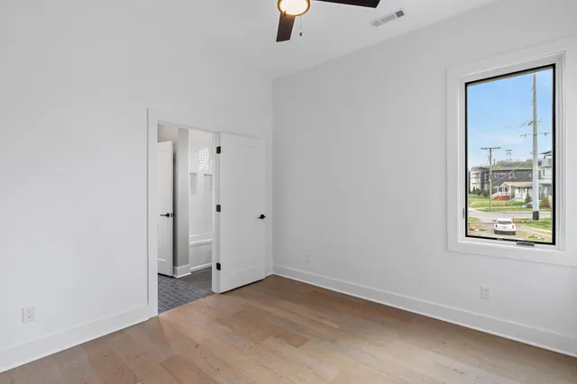 an empty room with windows and closet