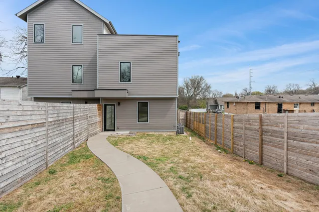 a view of a house with a wooden fence