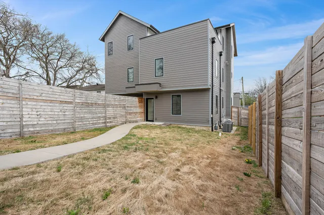 a view of a house with a wooden fence