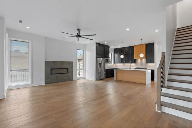 a view of kitchen with sink and refrigerator