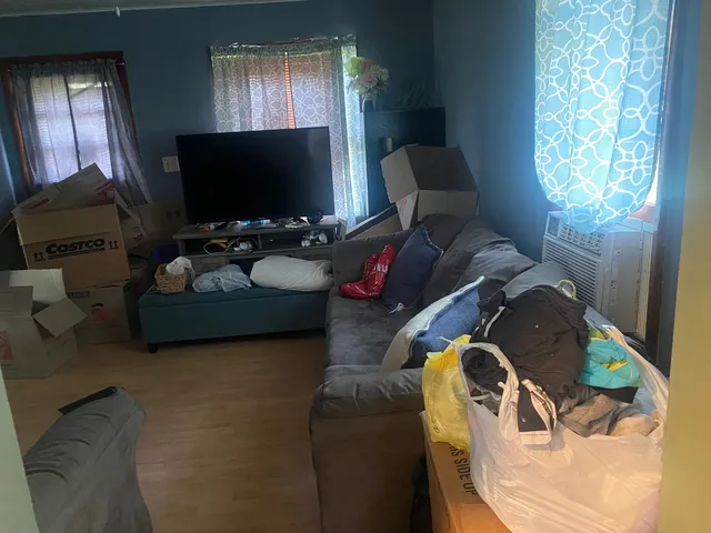 a living room with furniture and a flat screen tv