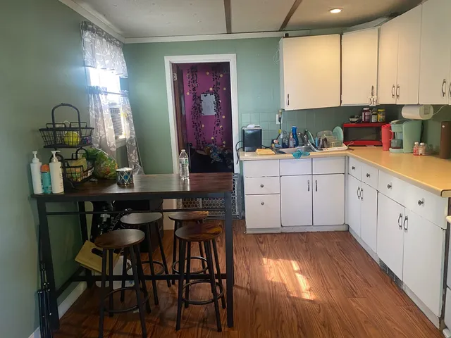 a kitchen with stainless steel appliances granite countertop a stove top oven a sink and cabinets