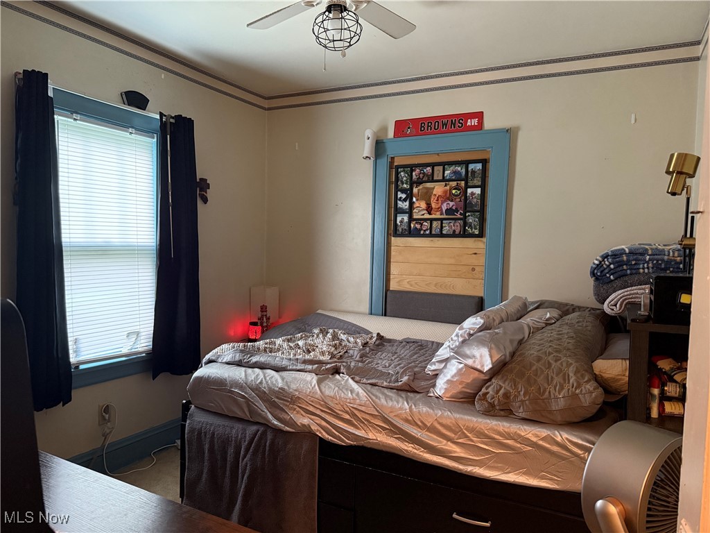 878 Brittain Road Akron, OH 44305 - Photo 16 of 16 Bedroom with a ceiling fan and baseboards
