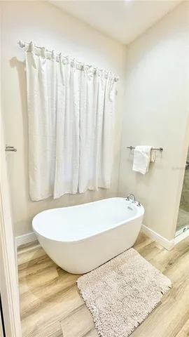 a bathroom with a bathtub and shower