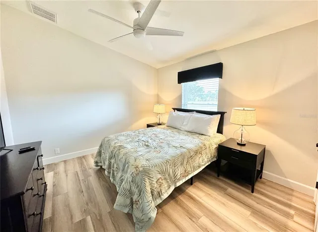 a bedroom with a bed and a painting on the wall