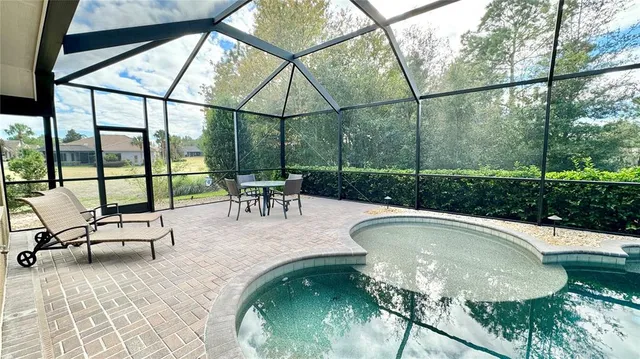 a swimming pool with outdoor seating outdoor seating and yard