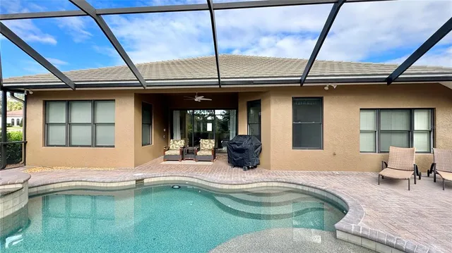 a swimming pool with outdoor seating