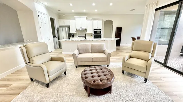 a living room with furniture and a large mirror
