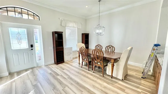 a view of a dining room with furniture and a chandelier