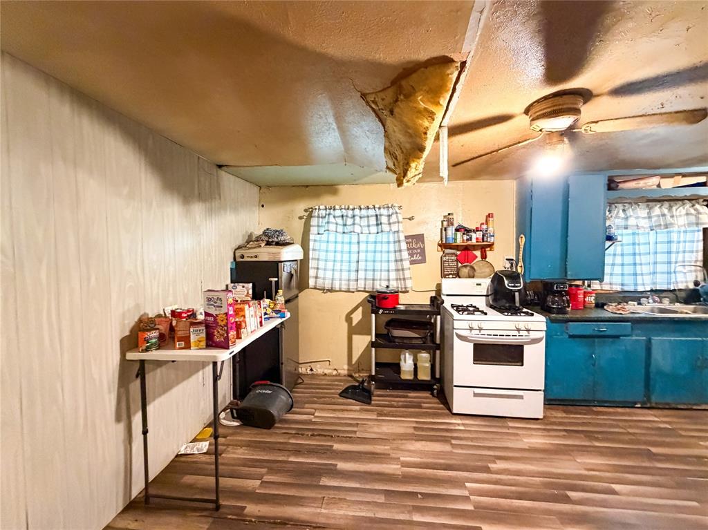 506 North Ave B Haskell, TX 79521 - Photo 4 of 13 a view of a kitchen with appliances and cabinets