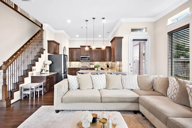 a view of living room kitchen with furniture and wooden floor