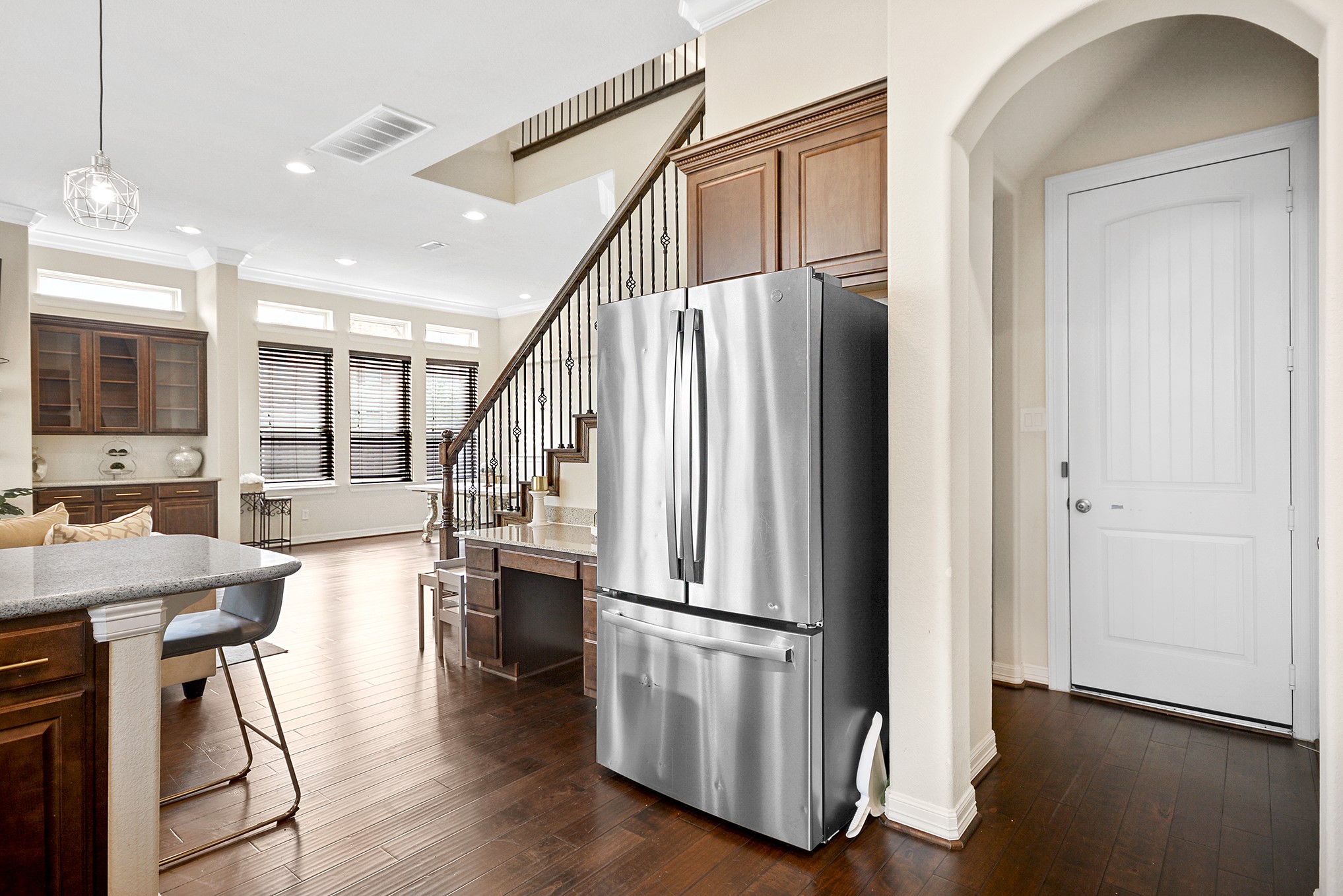 13204 Leighton Gardens Drive Houston, TX 77077 - Photo 14 of 35 a kitchen with stainless steel appliances granite countertop a refrigerator a stove a sink and a dining table with wooden floor