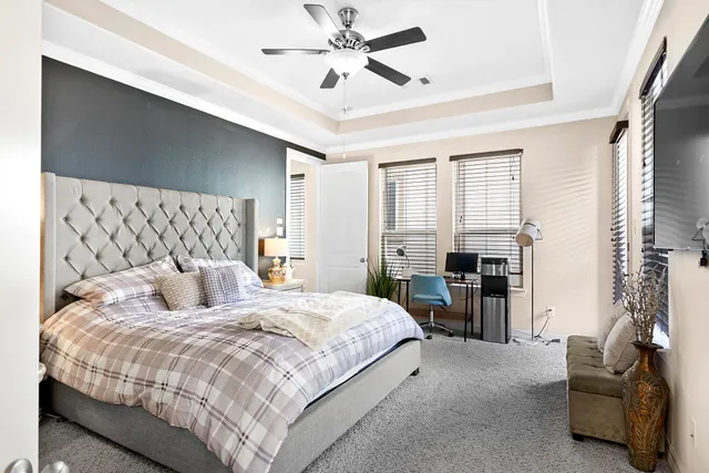 a bedroom with a large bed couch and a window