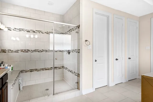 a bathroom with a glass shower door