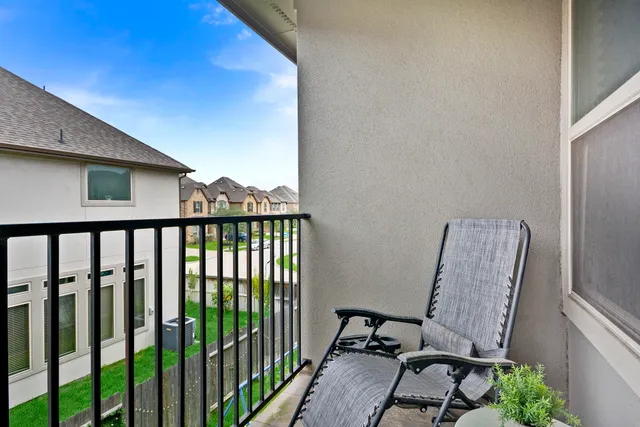 a view of a chair and table in the balcony