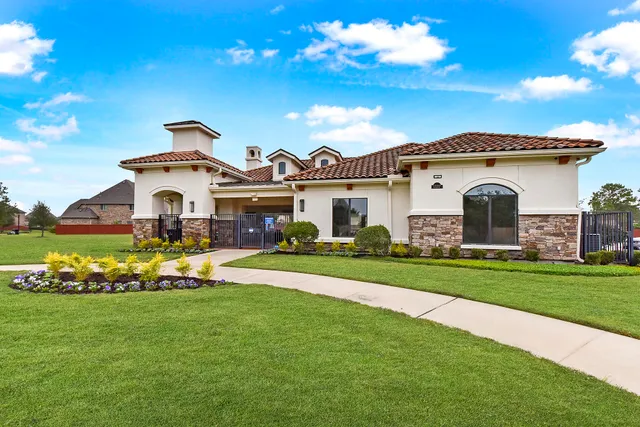 a front view of a house with a garden and yard