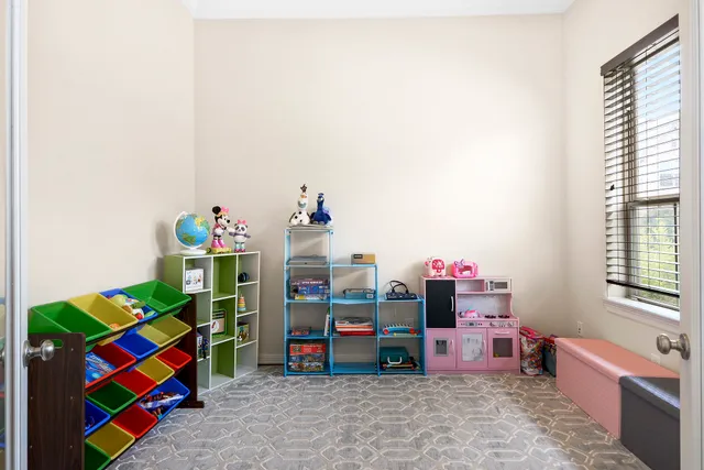 a living room with furniture kitchen view and a large window