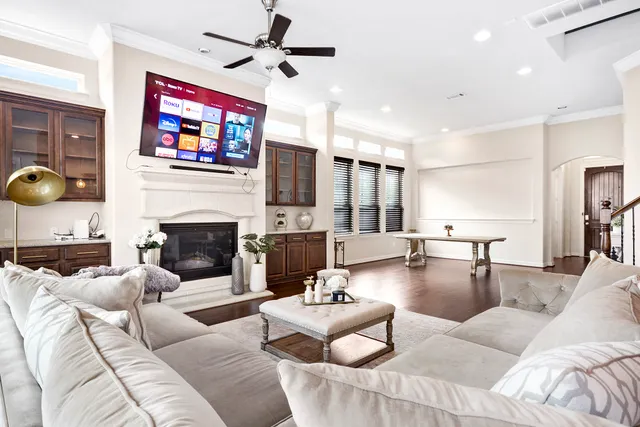 a living room with furniture a fireplace and a flat screen tv