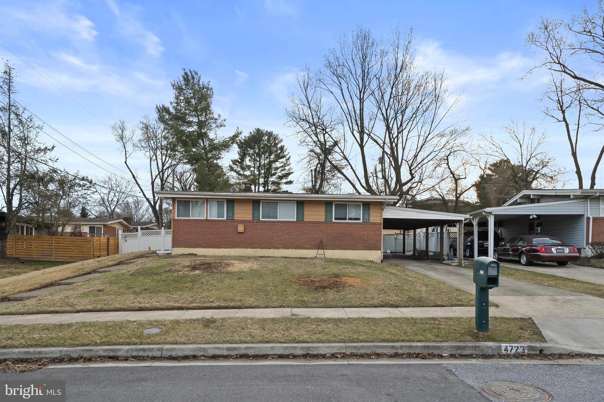 a view of a house with a yard covered with snow in front of house