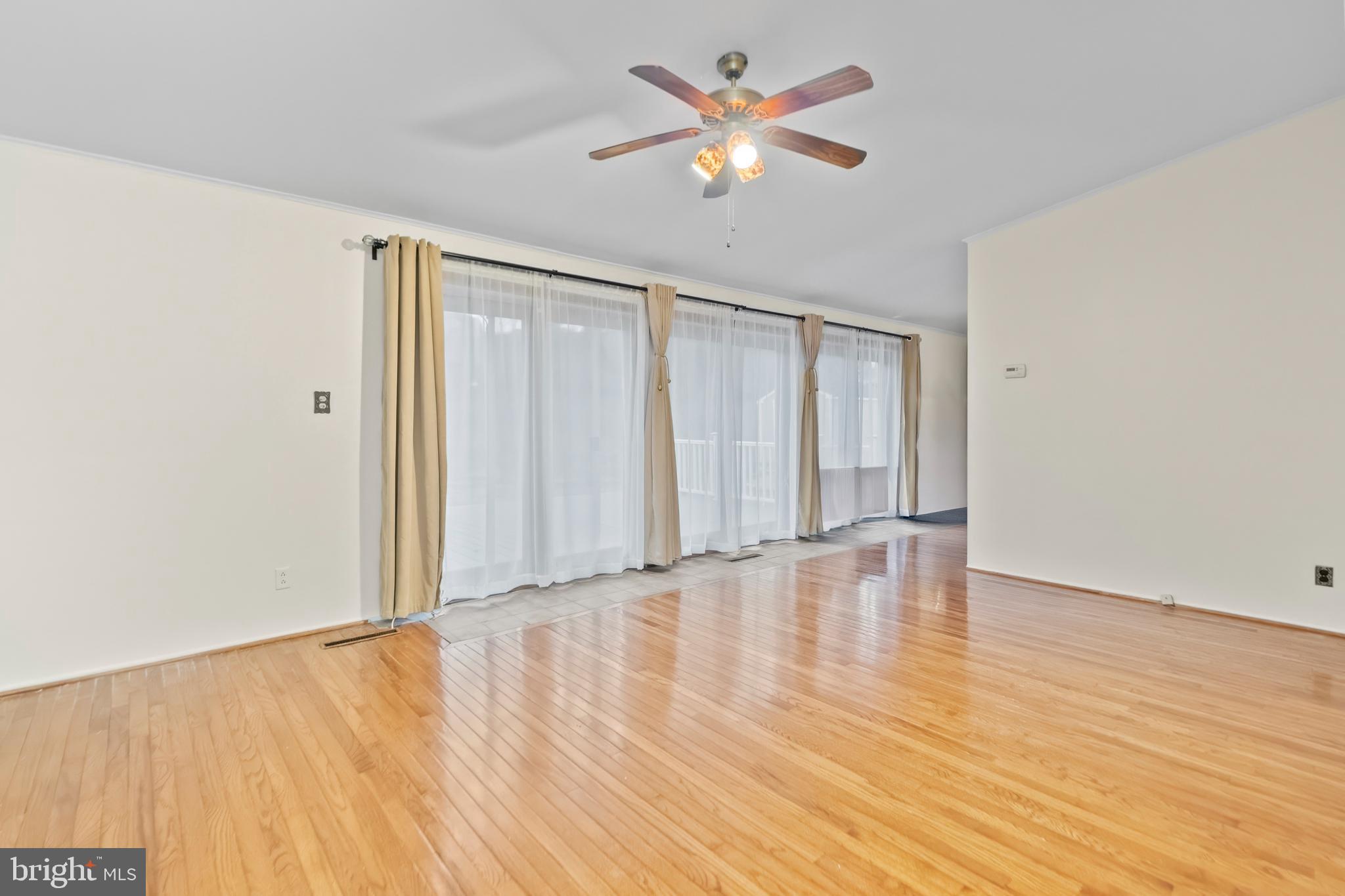 4723 Maryknoll Road Baltimore, MD 21208 - Photo 18 of 24 wooden floor in an empty room with a window