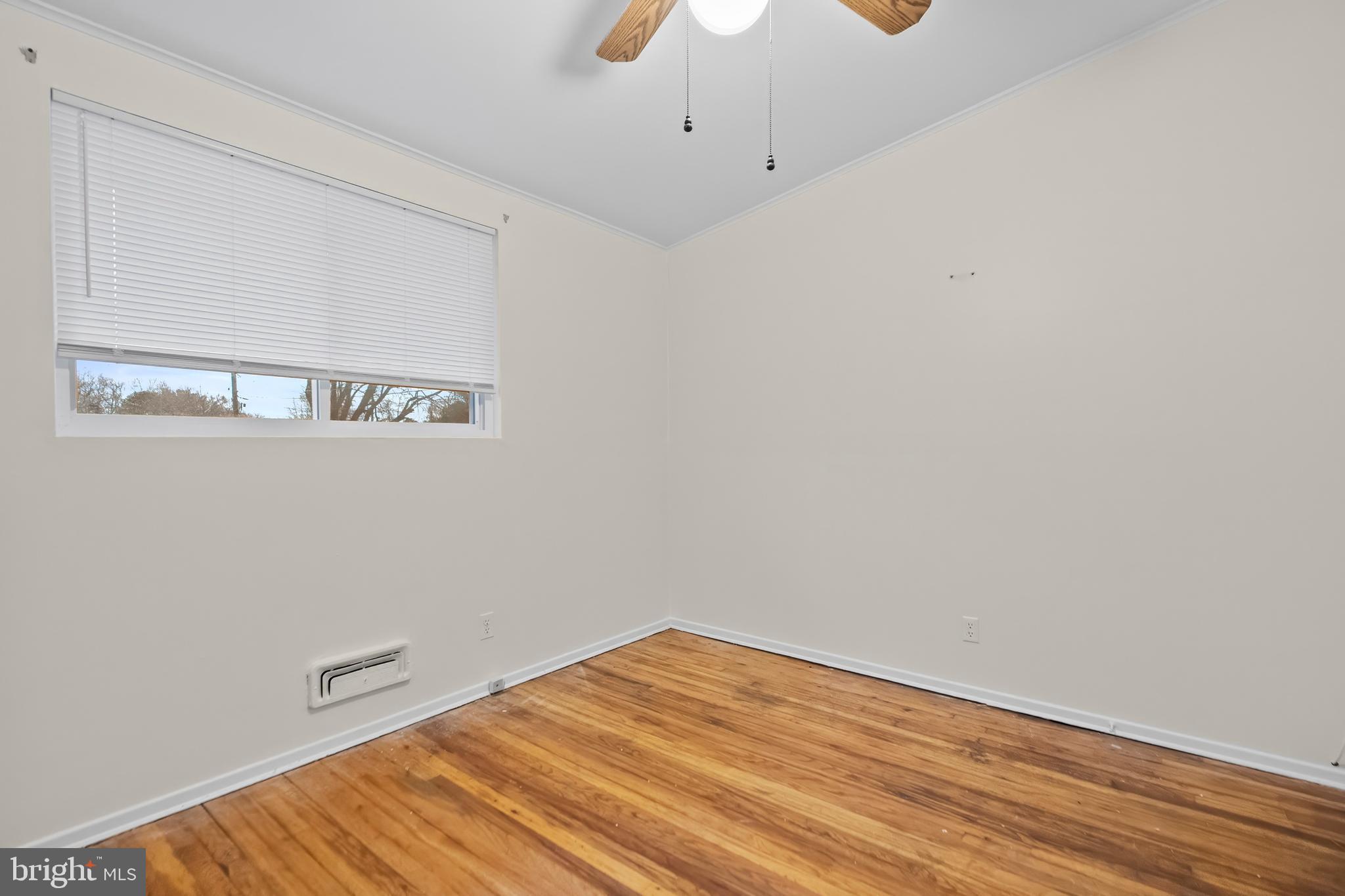 4723 Maryknoll Road Baltimore, MD 21208 - Photo 21 of 24 a view of a room with wooden floor and white walls