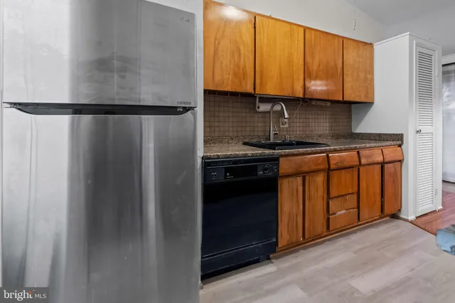 a kitchen with wooden cabinets and a stove top oven