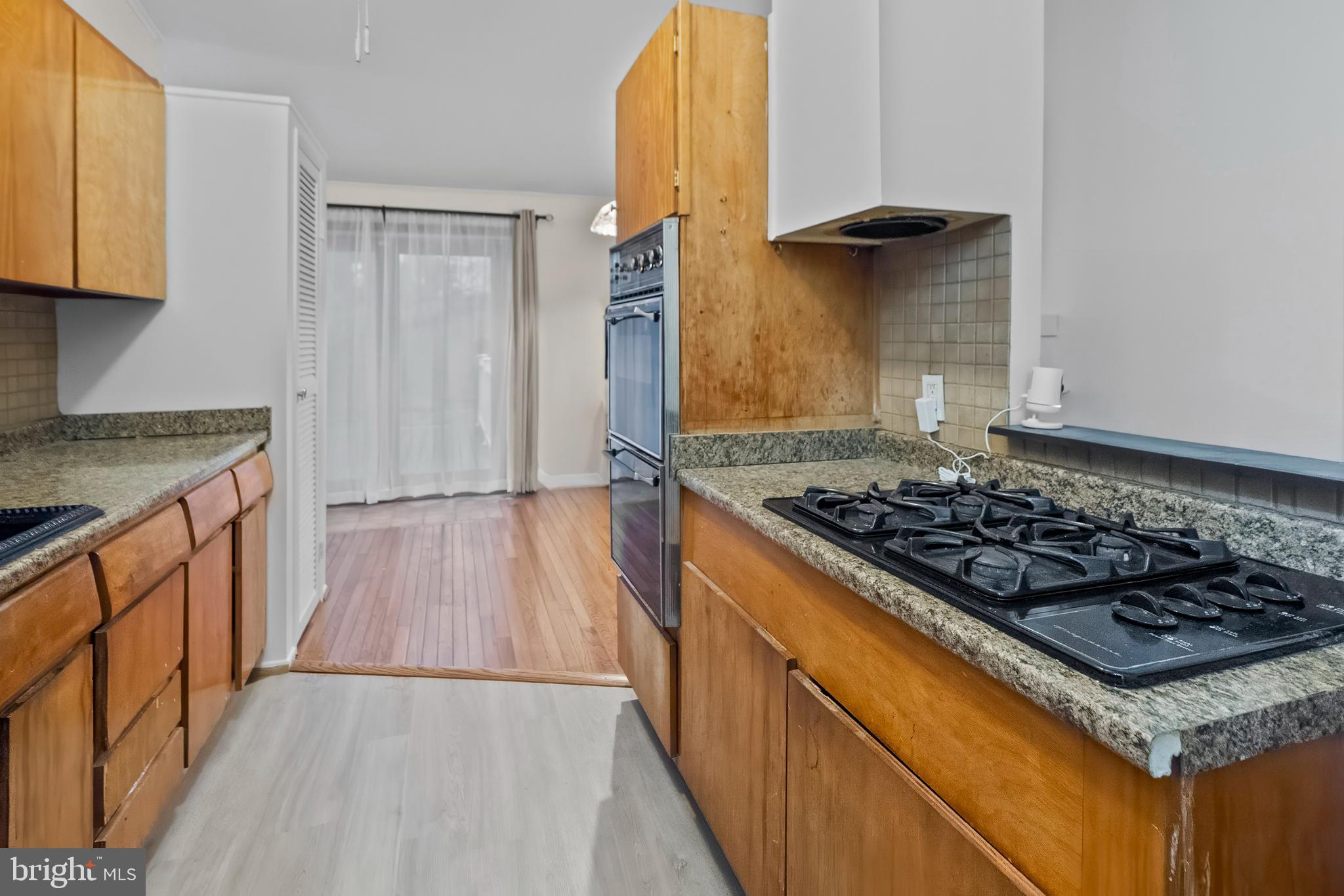 4723 Maryknoll Road Baltimore, MD 21208 - Photo 23 of 24 a kitchen with wooden cabinets and a stove top oven