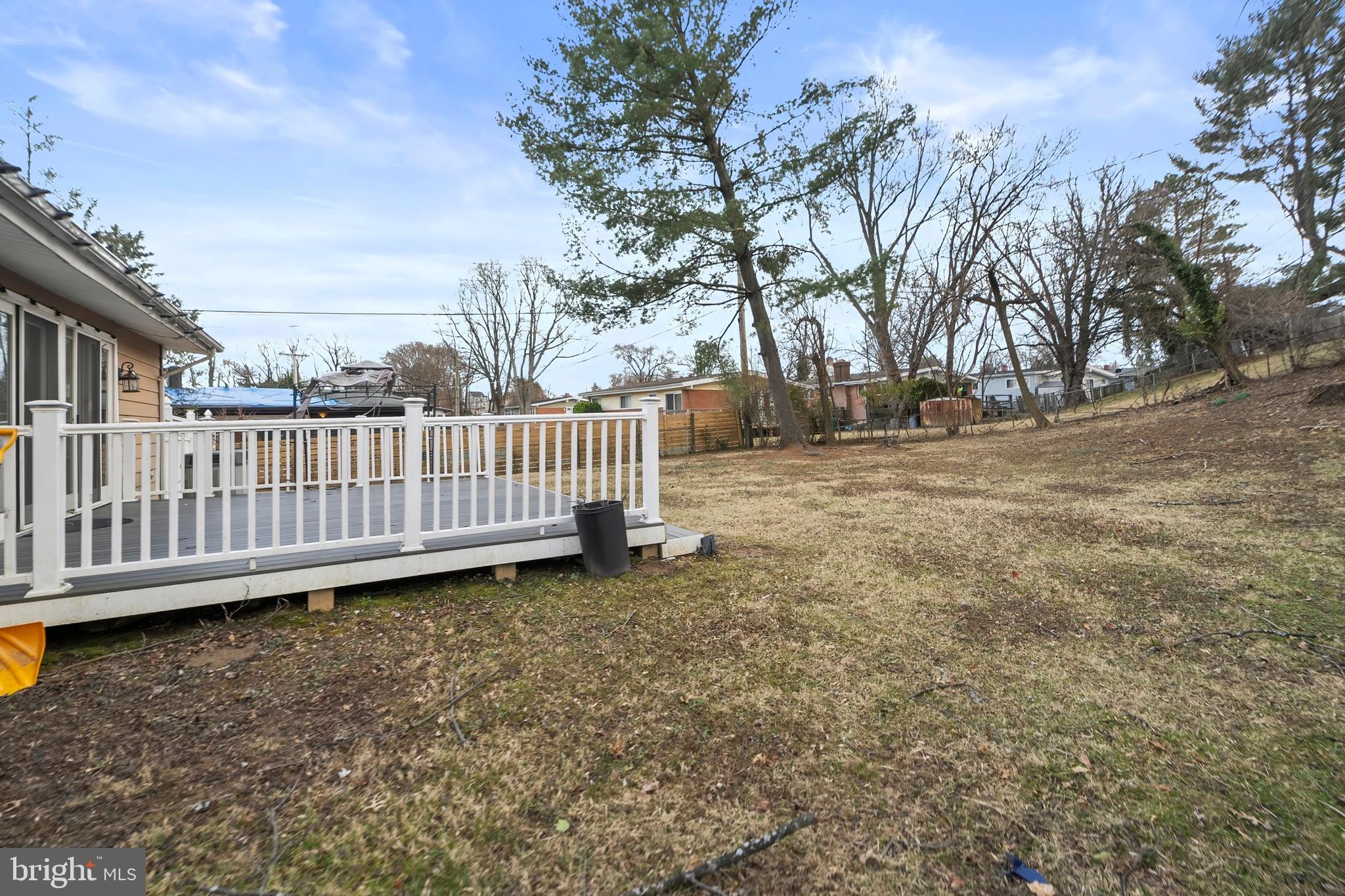 4723 Maryknoll Road Baltimore, MD 21208 - Photo 3 of 24 a view of a yard with wooden fence and trees