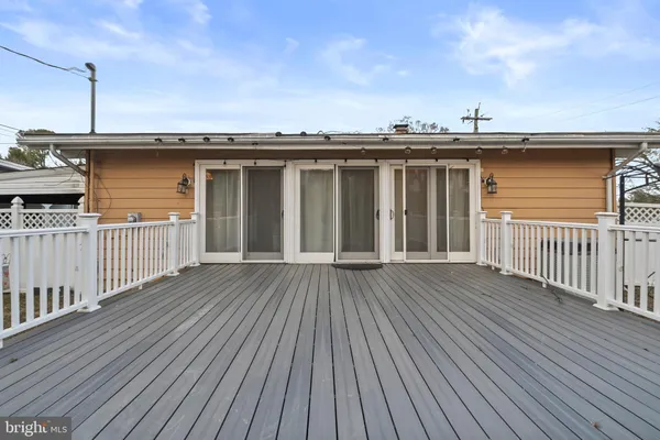 a view of a house with wooden deck