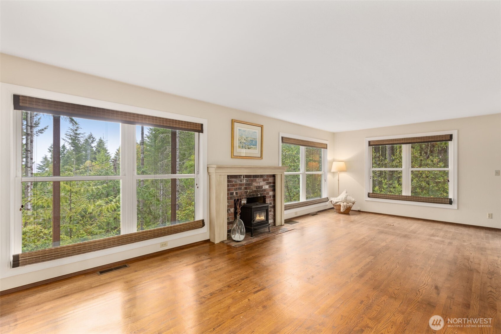 100 East Twanoh Heights Road South Belfair, WA 98528 - Photo 6 of 40 wooden floor fireplace and windows in an empty room