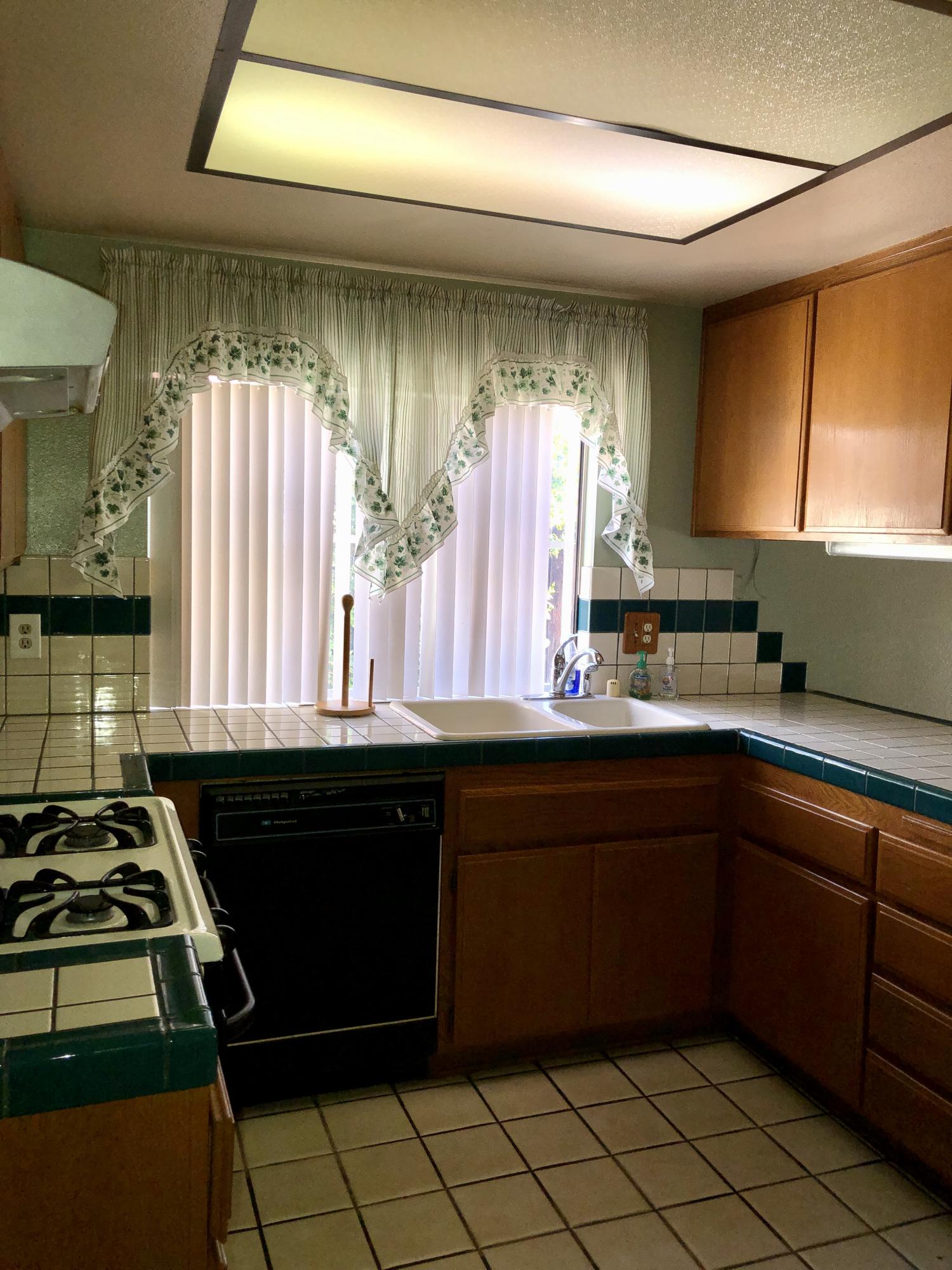 11368 Rancho Del Oro Drive Riverside, CA 92505 - Photo 6 of 20 a kitchen with a sink a stove and a window