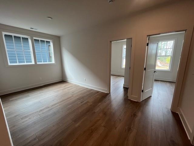 3932 Calm Court Chamblee, GA 30341 - Photo 19 of 27 a view of an empty room with wooden floor and a window
