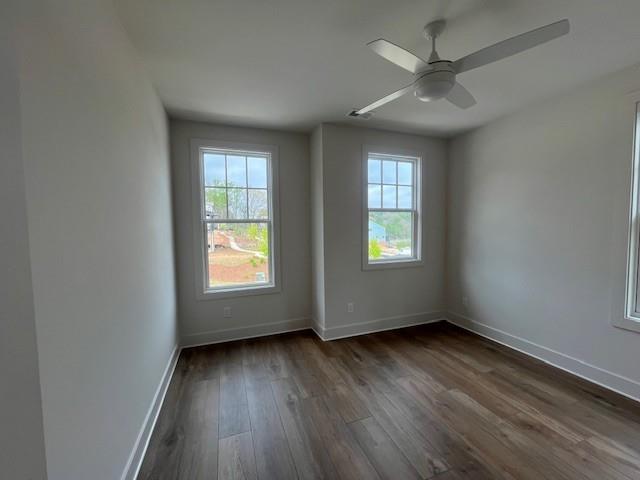 3932 Calm Court Chamblee, GA 30341 - Photo 22 of 27 an empty room with wooden floor fan and windows