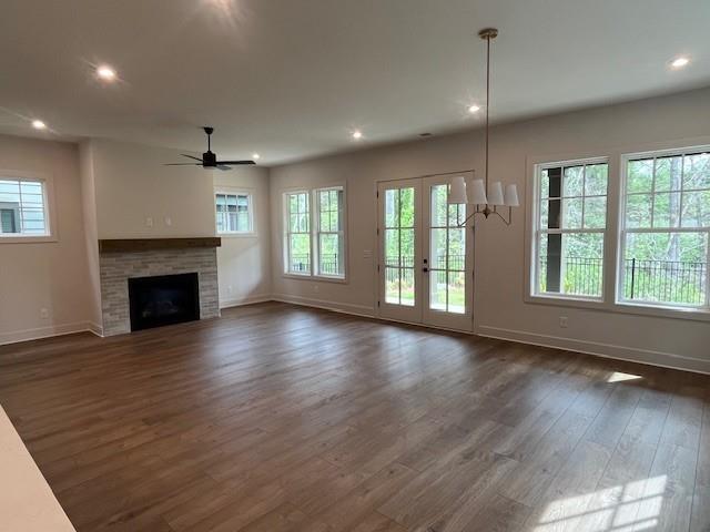 3932 Calm Court Chamblee, GA 30341 - Photo 5 of 27 an empty room with wooden floor fireplace and windows