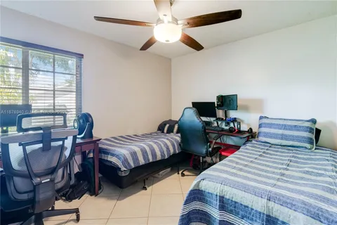 a bedroom with two beds and a desk