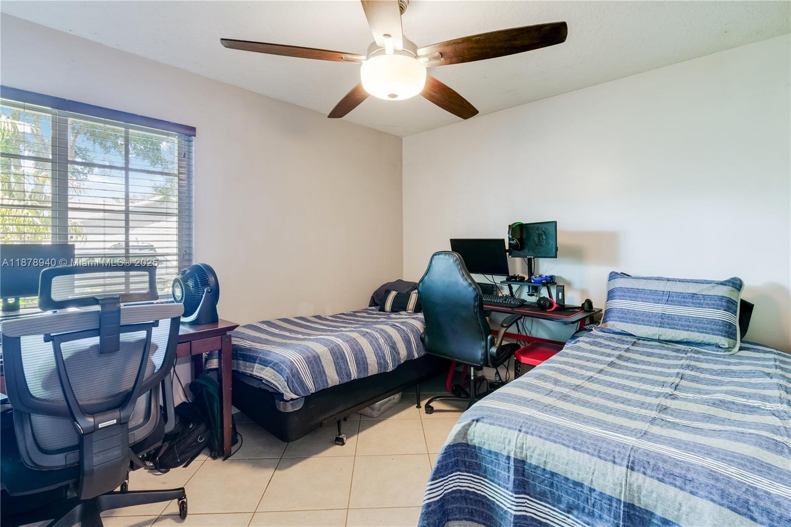 15025 Southwest 141st Court Miami, FL 33186 - Photo 16 of 29 a bedroom with two beds and a desk