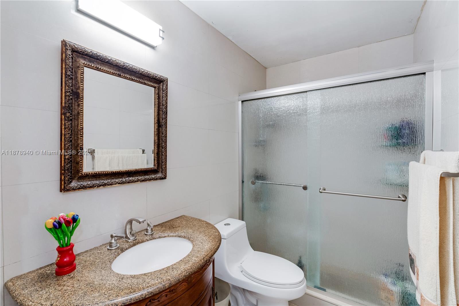 15025 Southwest 141st Court Miami, FL 33186 - Photo 17 of 29 a bathroom with a sink toilet and shower