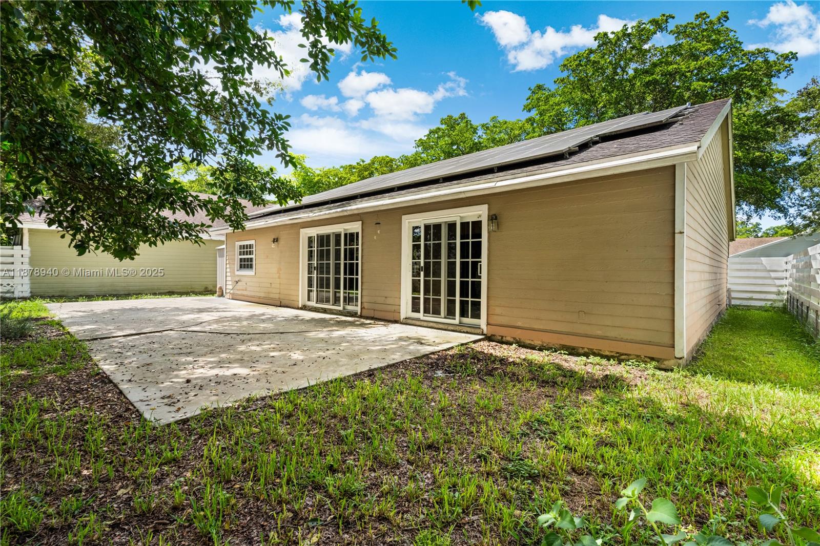 15025 Southwest 141st Court Miami, FL 33186 - Photo 20 of 29 a backyard of a house with plants and tree