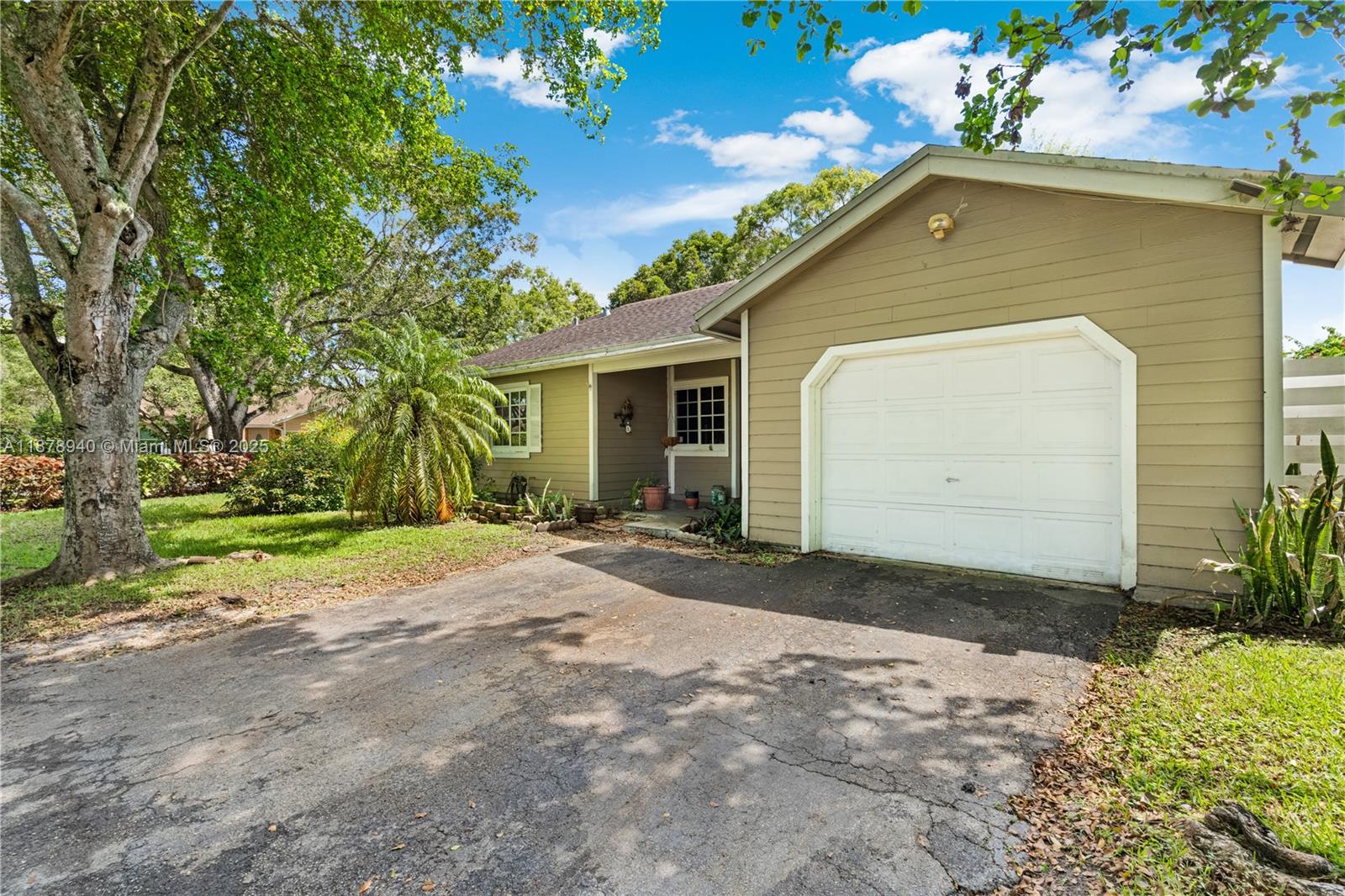 15025 Southwest 141st Court Miami, FL 33186 - Photo 3 of 29 a front view of a house with a yard and garage