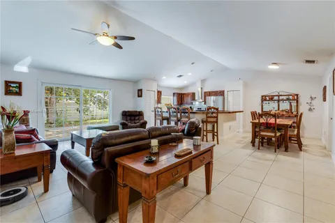 a living room with lots of furniture and a large window