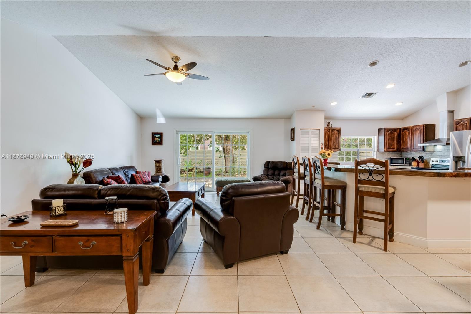 15025 Southwest 141st Court Miami, FL 33186 - Photo 9 of 29 a living room with furniture a dining table and a piano table