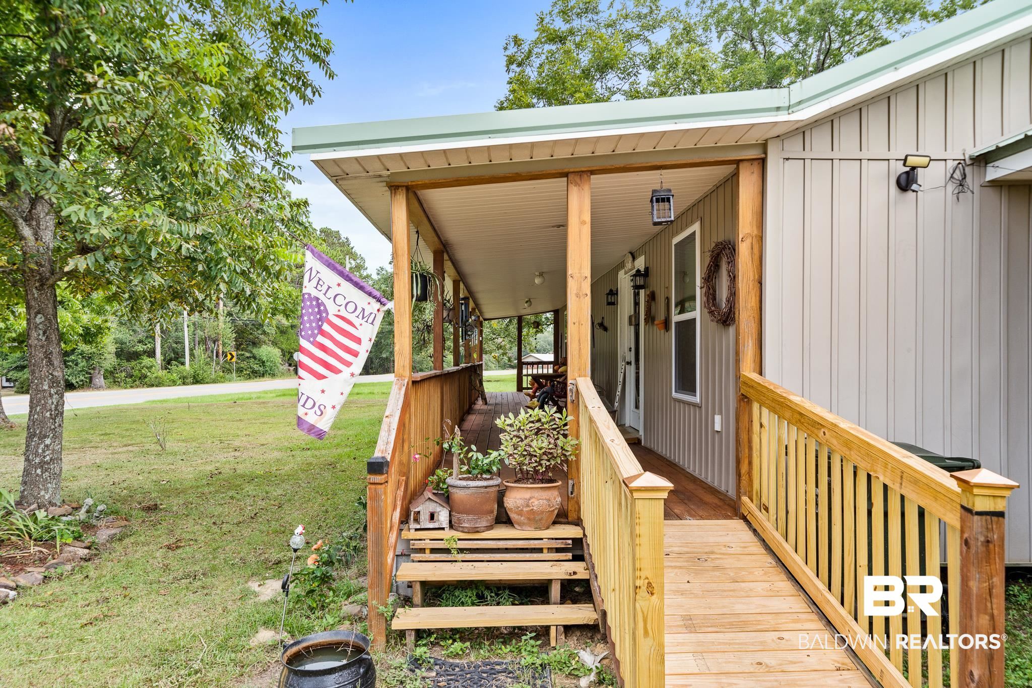 11528 Whitehouse Fork Road Bay Minette, AL 36507 - Photo 5 of 37 Exterior space with a porch and a yard