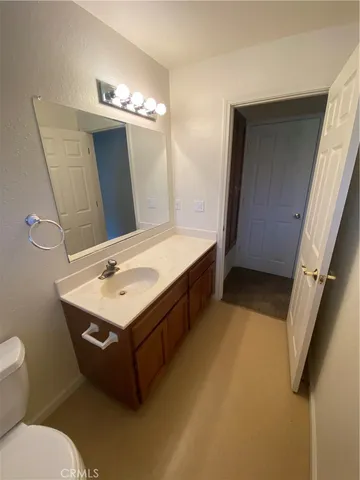 a bathroom with a sink double vanity granite and a mirror